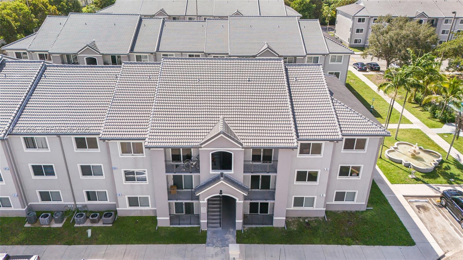 15410 Southwest 284th Street, Unit 8208 Homestead, FL 33033 - Photo 3 of 20 a view of a white building among the yard