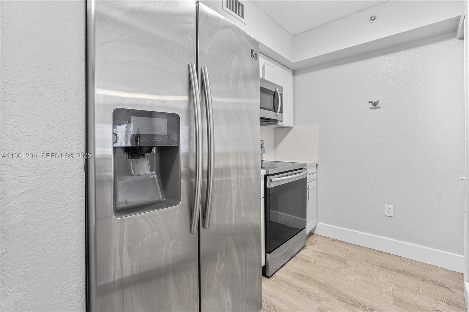 15410 Southwest 284th Street, Unit 8208 Homestead, FL 33033 - Photo 8 of 20 a kitchen with cabinets and stainless steel appliances