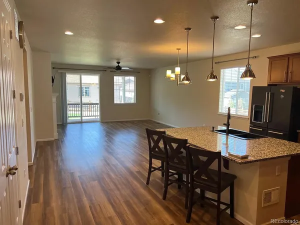 a view of a kitchen with a table and chairs