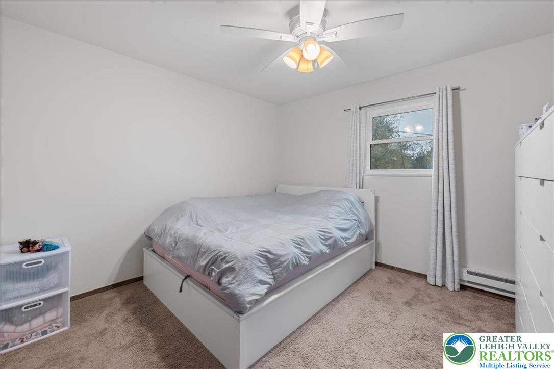 217 Coach Road Tobyhanna, PA 18466 - Photo 21 of 35 a spacious bedroom with a bed and a window