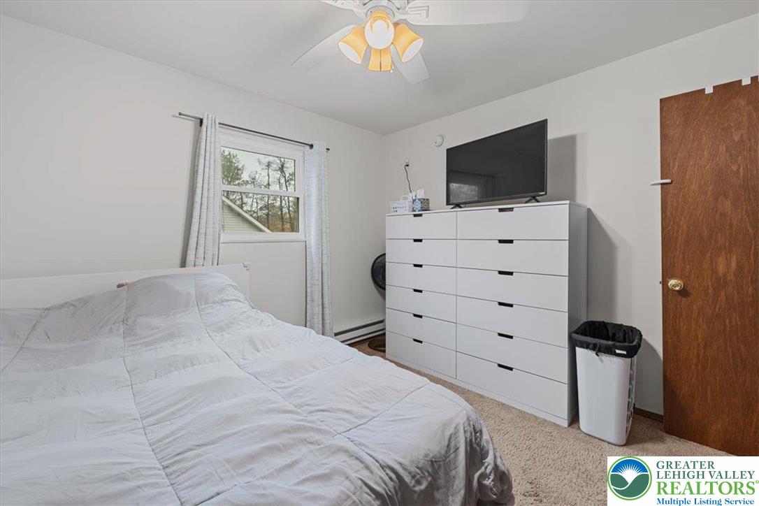 217 Coach Road Tobyhanna, PA 18466 - Photo 22 of 35 a bedroom with a bed and a flat screen tv