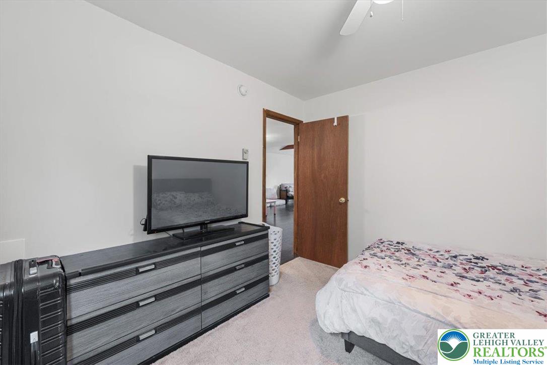 217 Coach Road Tobyhanna, PA 18466 - Photo 24 of 35 a bedroom with a bed and flat screen tv