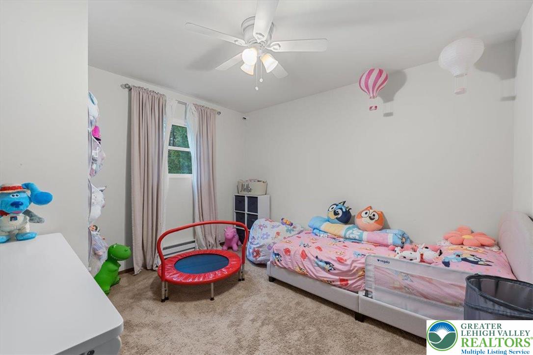 217 Coach Road Tobyhanna, PA 18466 - Photo 26 of 35 a bedroom with a bed and a chandelier