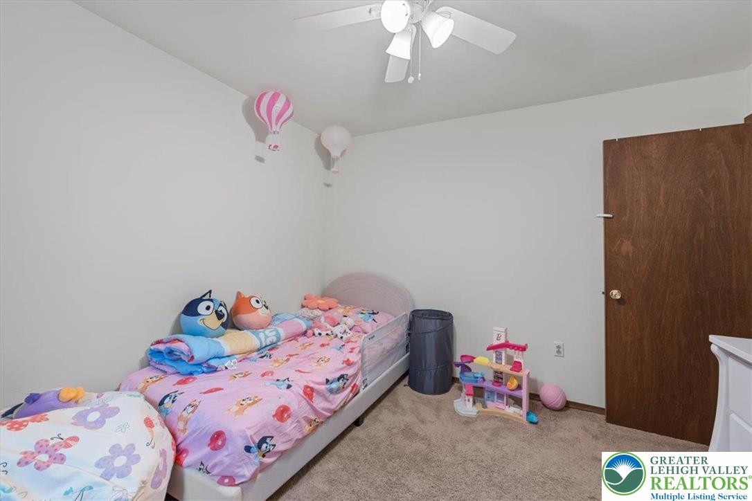 217 Coach Road Tobyhanna, PA 18466 - Photo 27 of 35 a bedroom with a bed and chandelier