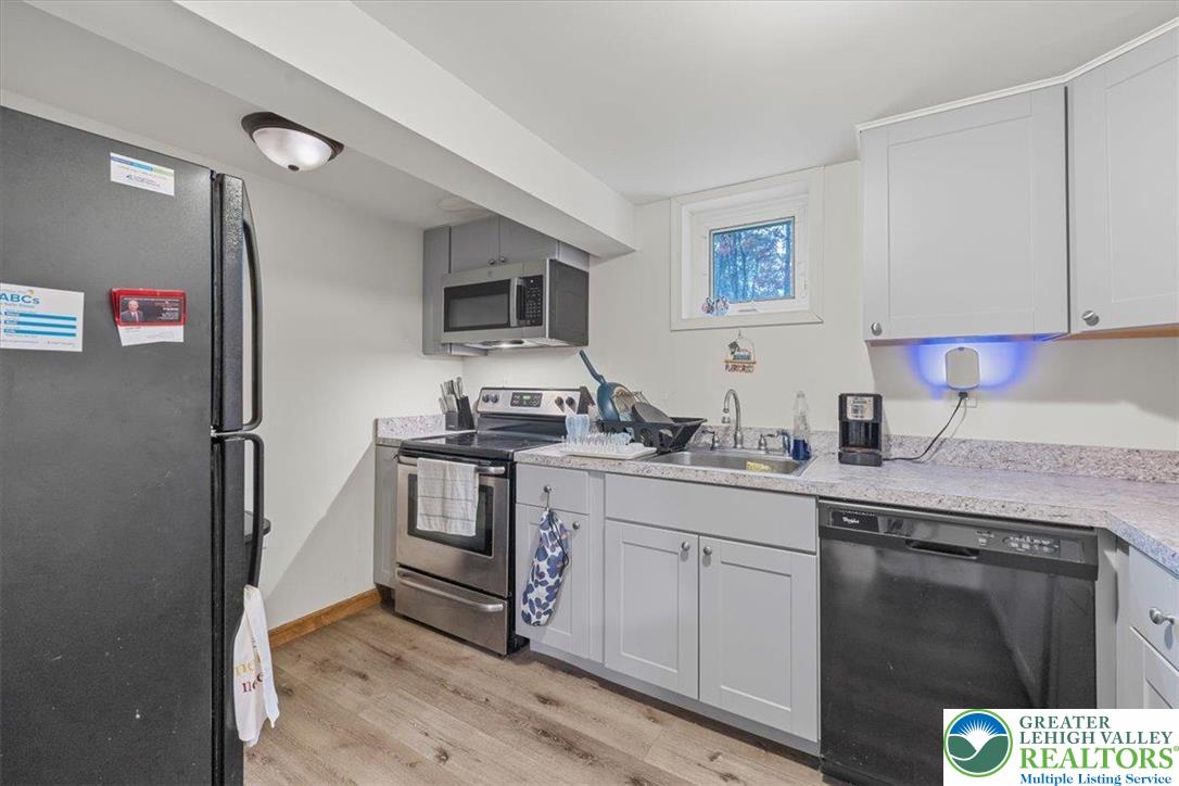 217 Coach Road Tobyhanna, PA 18466 - Photo 9 of 35 a kitchen with stainless steel appliances granite countertop a stove a sink and a refrigerator