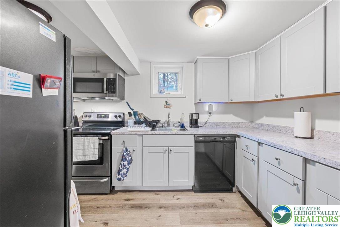 217 Coach Road Tobyhanna, PA 18466 - Photo 10 of 35 a kitchen with stainless steel appliances granite countertop a sink stove and cabinets