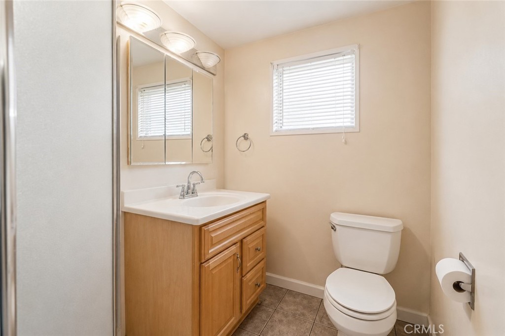 2209 Queensberry Road Pasadena, CA 91104 - Photo 25 of 44 a bathroom with a toilet sink vanity and mirror