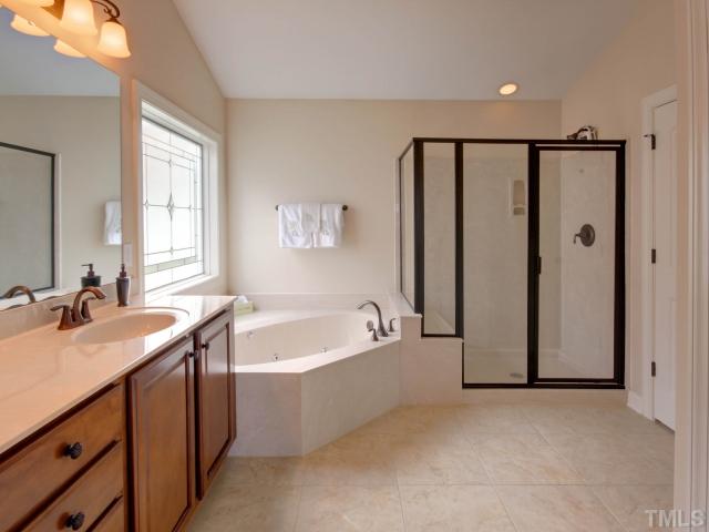 2412 Treen Street Raleigh, NC 27614 - Photo 15 of 25 Master bath with corner tub, glass shower and his and hers sinks