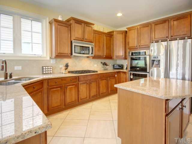 2412 Treen Street Raleigh, NC 27614 - Photo 6 of 25 Open concept kitchen with granite counter tops, stainless appliances and great center island