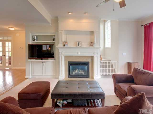 2412 Treen Street Raleigh, NC 27614 - Photo 10 of 25 Family room with built ins, fireplace with gas logs and a wall of windows overlooking the rear yard