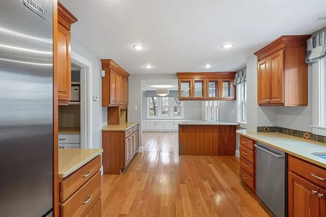 a kitchen with stainless steel appliances granite countertop a refrigerator and a sink