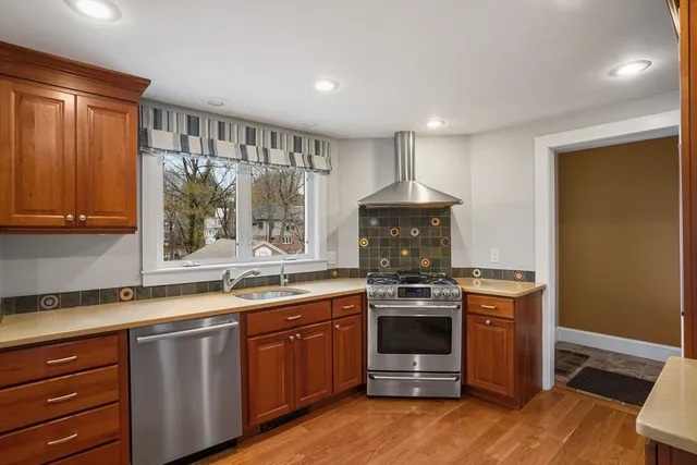 a kitchen with a sink stove and cabinets