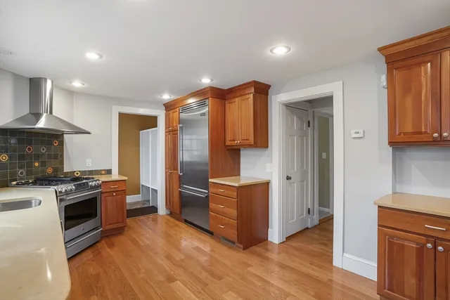 a kitchen with stainless steel appliances granite countertop a stove and a refrigerator