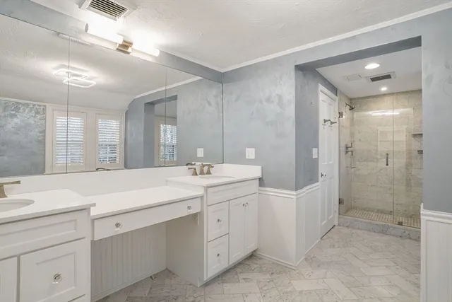 a spacious bathroom with a shower sink and mirror