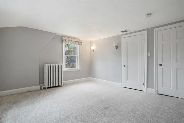 a view of a livingroom with an empty space and a window