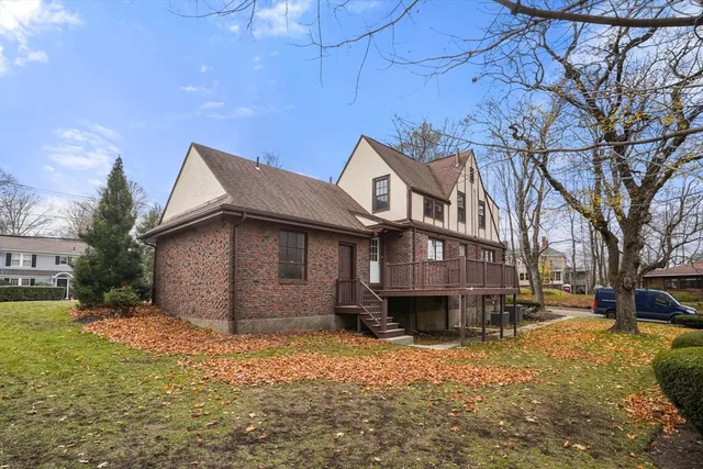 a front view of a house with a yard covered with snow