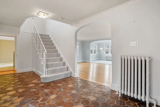 a view of a hallway with entryway and wooden floor