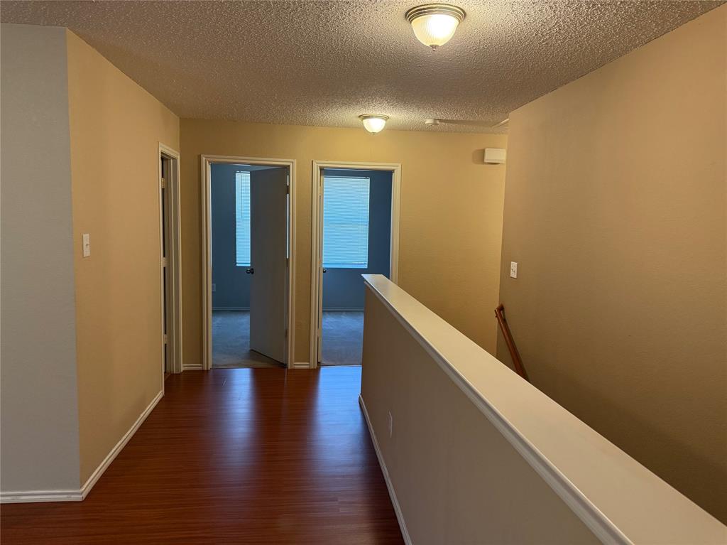 2011 Cap Rock Lane Grand Prairie, TX 75052 - Photo 9 of 9 a hallway with wooden floor