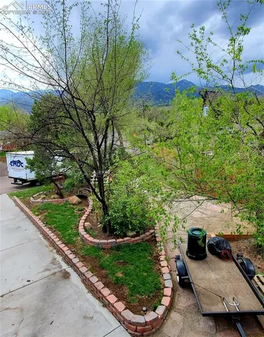 a view of house with a yard