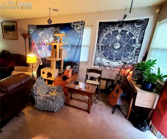 a bed sitting in a bedroom next to a window