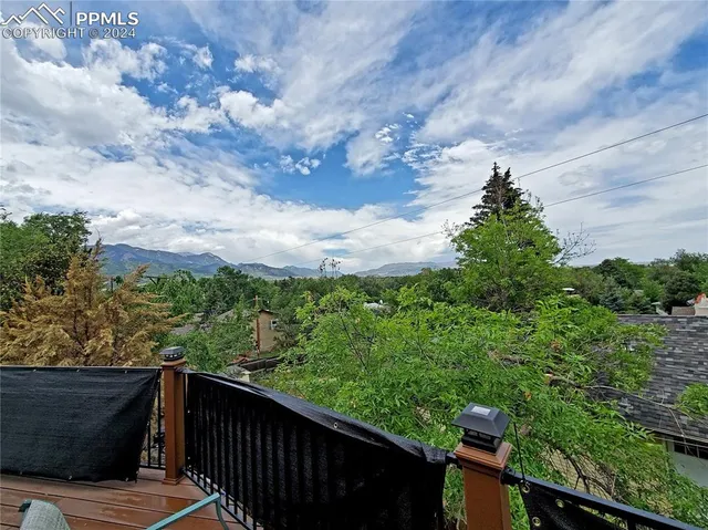 a balcony with wooden floor and city view