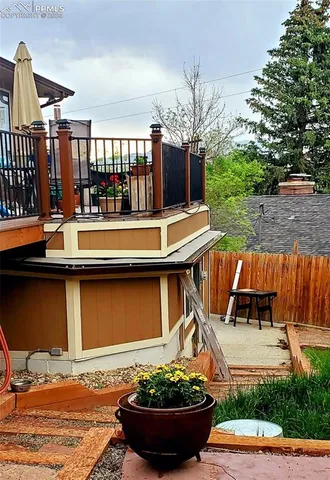 a view of a backyard with plants and outdoor seating