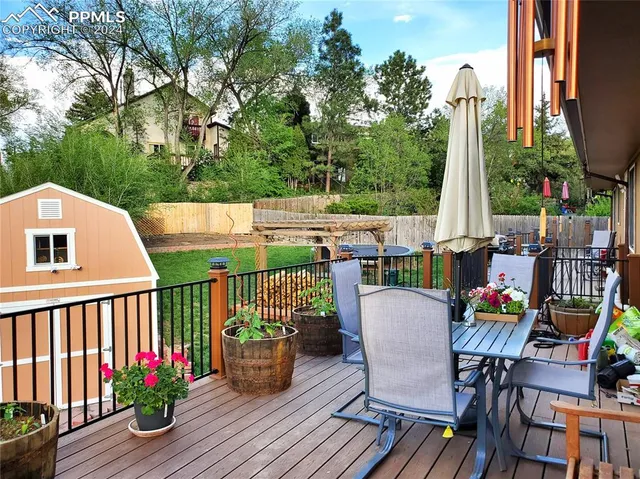 a view of balcony with furniture and garden