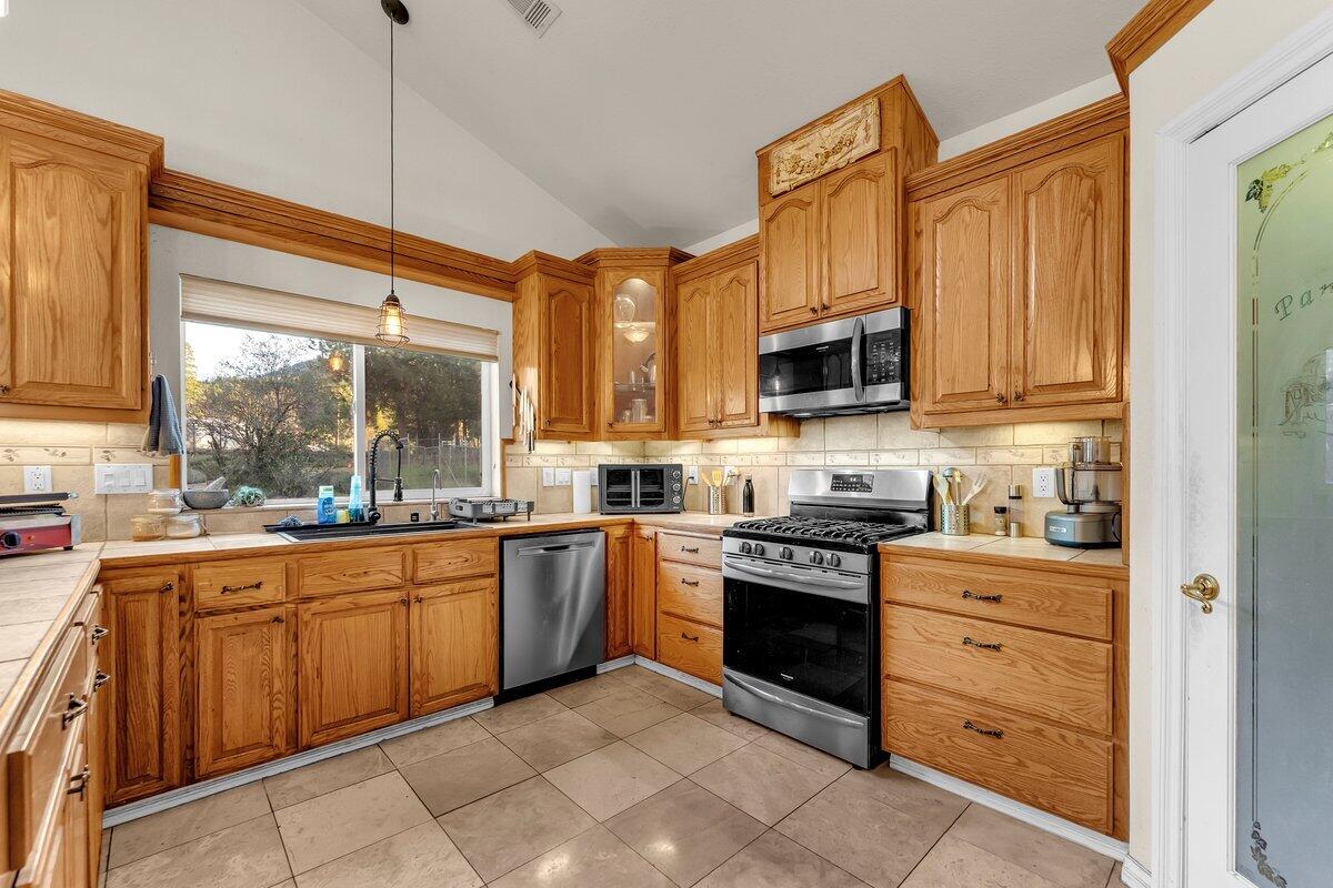 12757 Fern Road Whitmore, CA 96096 - Photo 17 of 62 a kitchen with stainless steel appliances granite countertop a stove and a sink