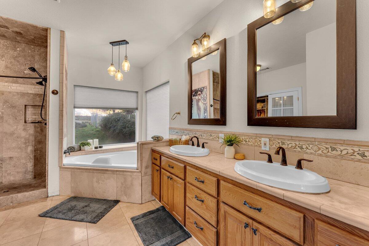 12757 Fern Road Whitmore, CA 96096 - Photo 22 of 62 a bathroom with a granite countertop sink mirror and bathtub