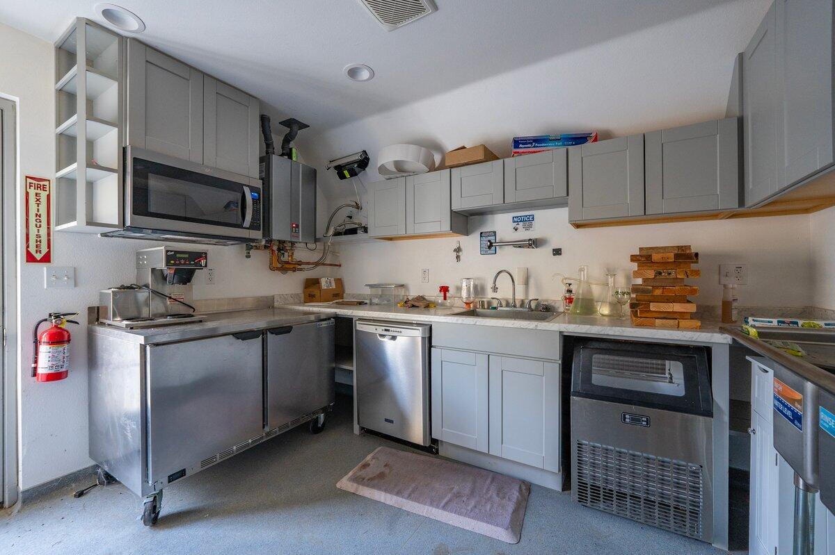 12757 Fern Road Whitmore, CA 96096 - Photo 41 of 62 a kitchen with granite countertop a sink a stove and cabinets
