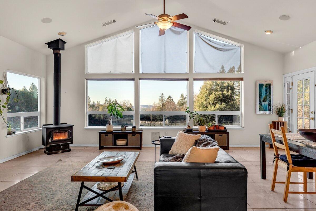 12757 Fern Road Whitmore, CA 96096 - Photo 10 of 62 a living room with furniture a large window and a flat screen tv