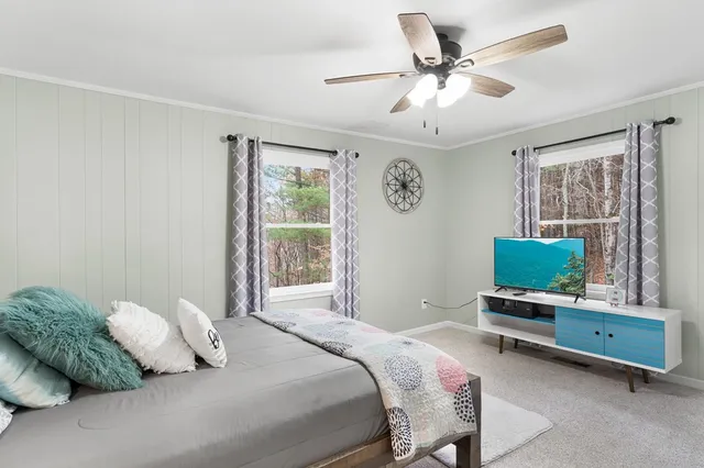 a bedroom with a large bed and a chandelier