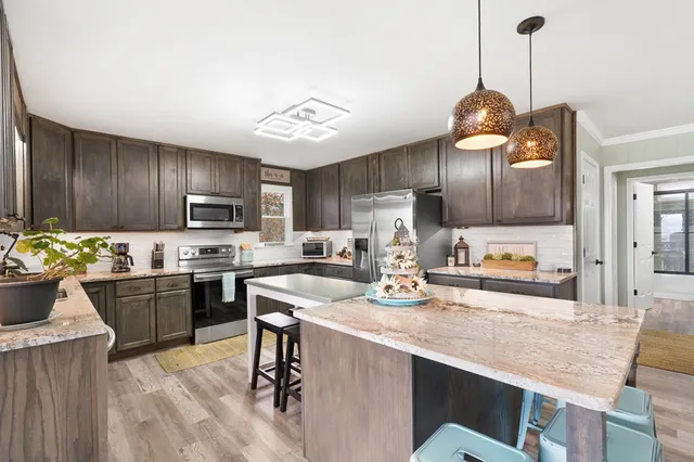 a kitchen with sink cabinets and stainless steel appliances