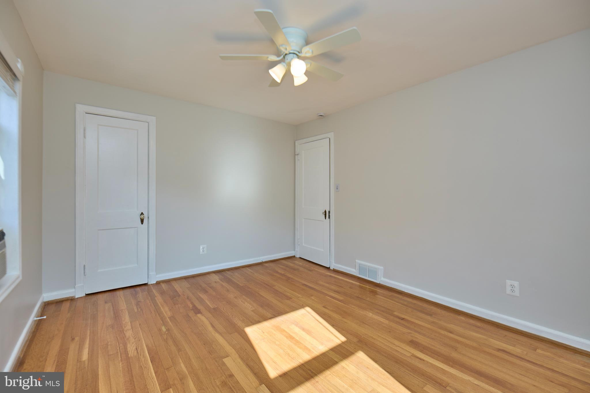 3727 2nd Street South Arlington, VA 22204 - Photo 14 of 30 an empty room with wooden floor and a ceiling fan