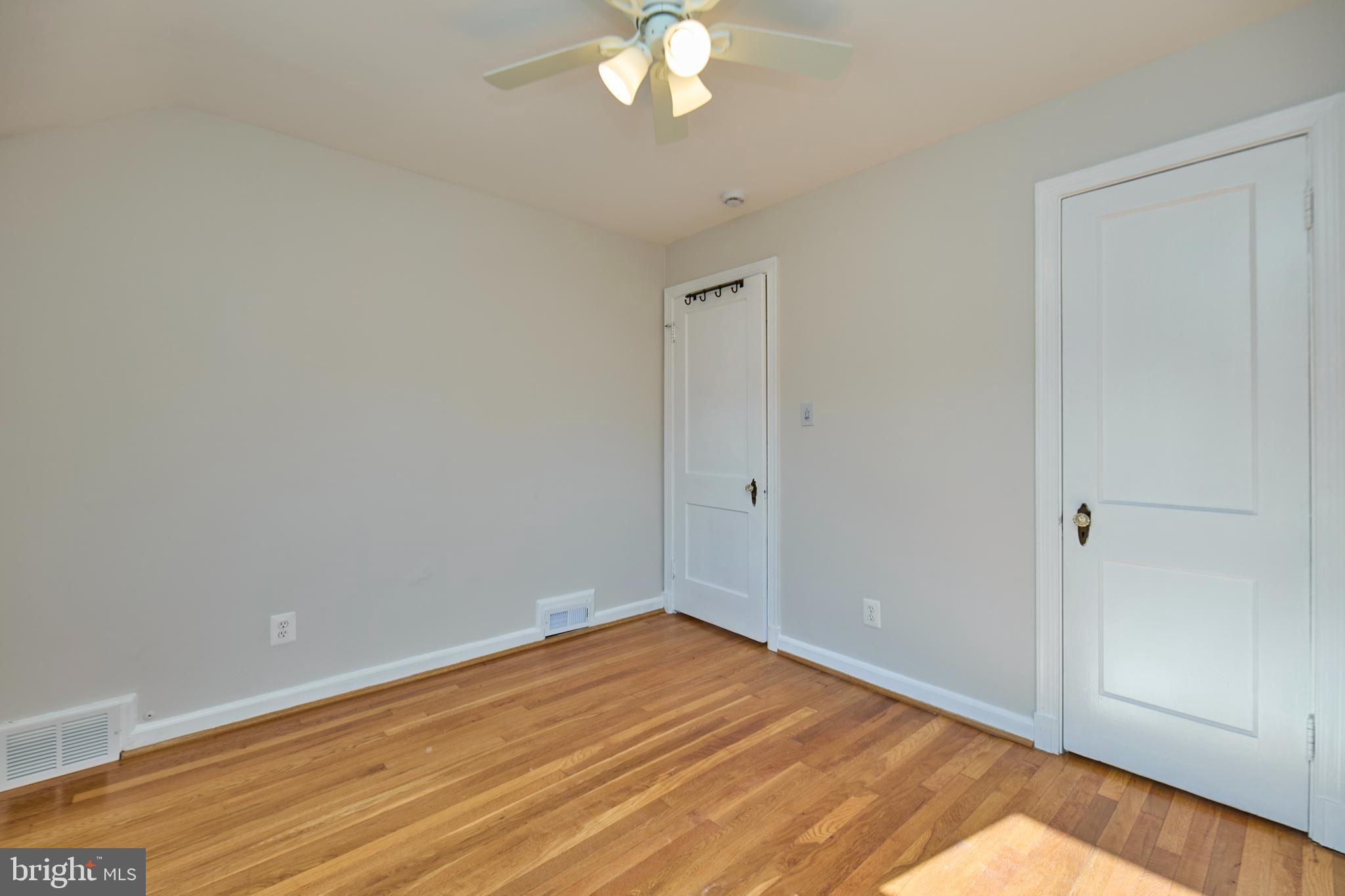 3727 2nd Street South Arlington, VA 22204 - Photo 18 of 30 a view of a room with wooden floor and a ceiling fan