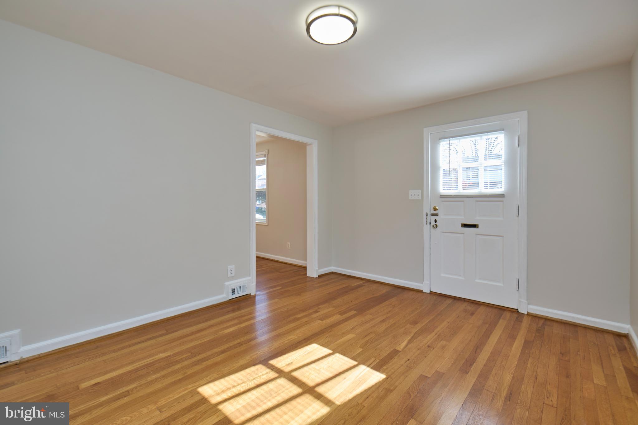 3727 2nd Street South Arlington, VA 22204 - Photo 2 of 30 an empty room with wooden floor and windows