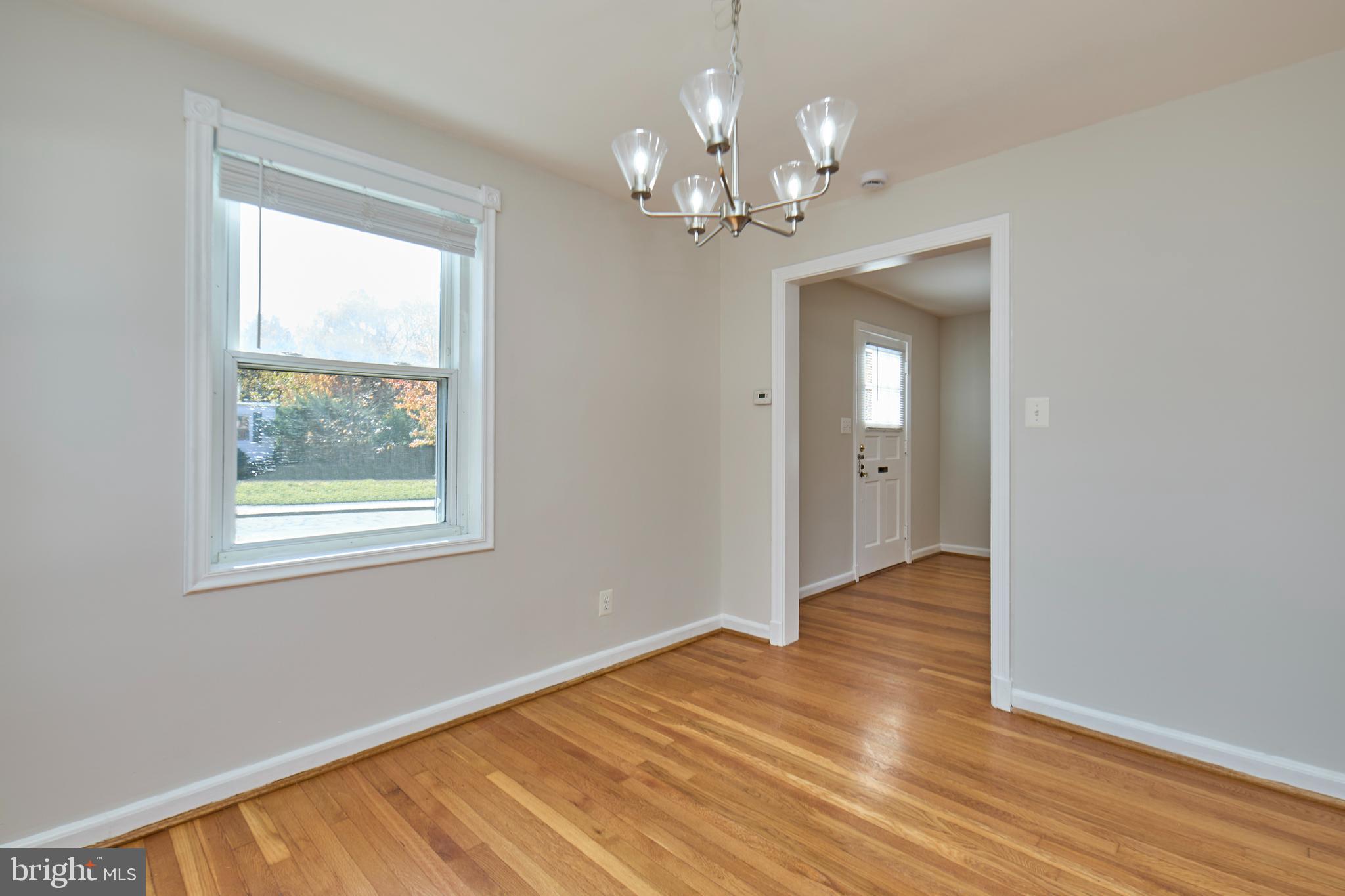 3727 2nd Street South Arlington, VA 22204 - Photo 8 of 30 a view of an empty room with wooden floor and a window