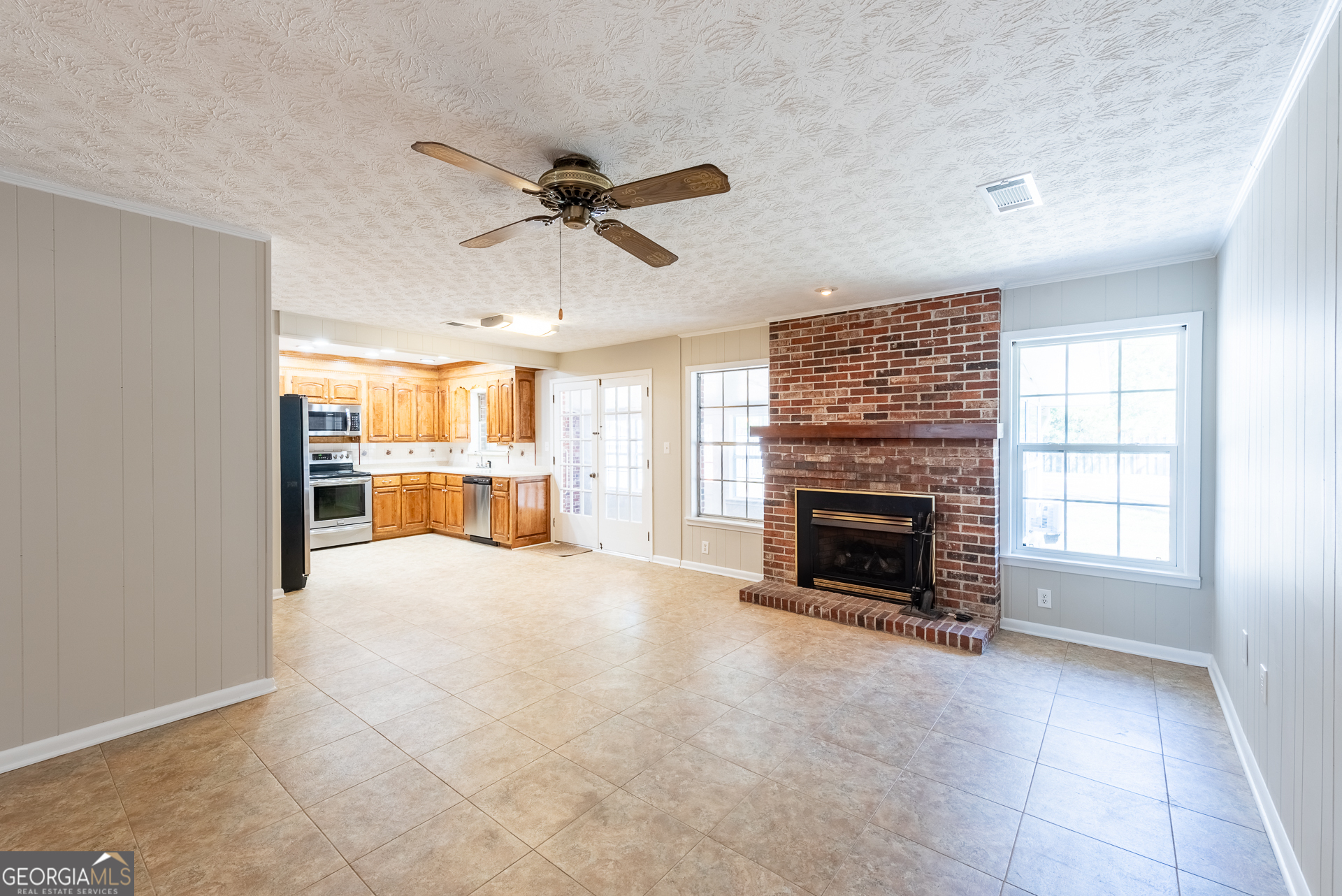 4582 St Johns Church Road Blackshear, GA 31516 - Photo 34 of 76 a view of a livingroom with a fireplace a ceiling fan and windows