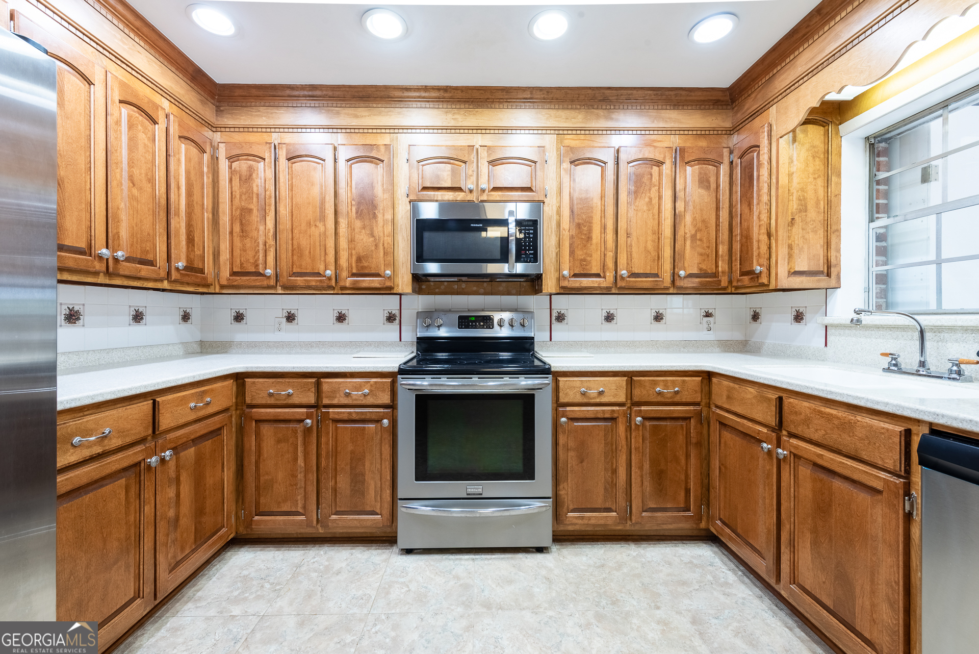 4582 St Johns Church Road Blackshear, GA 31516 - Photo 36 of 76 a kitchen with stainless steel appliances granite countertop a stove sink and cabinets