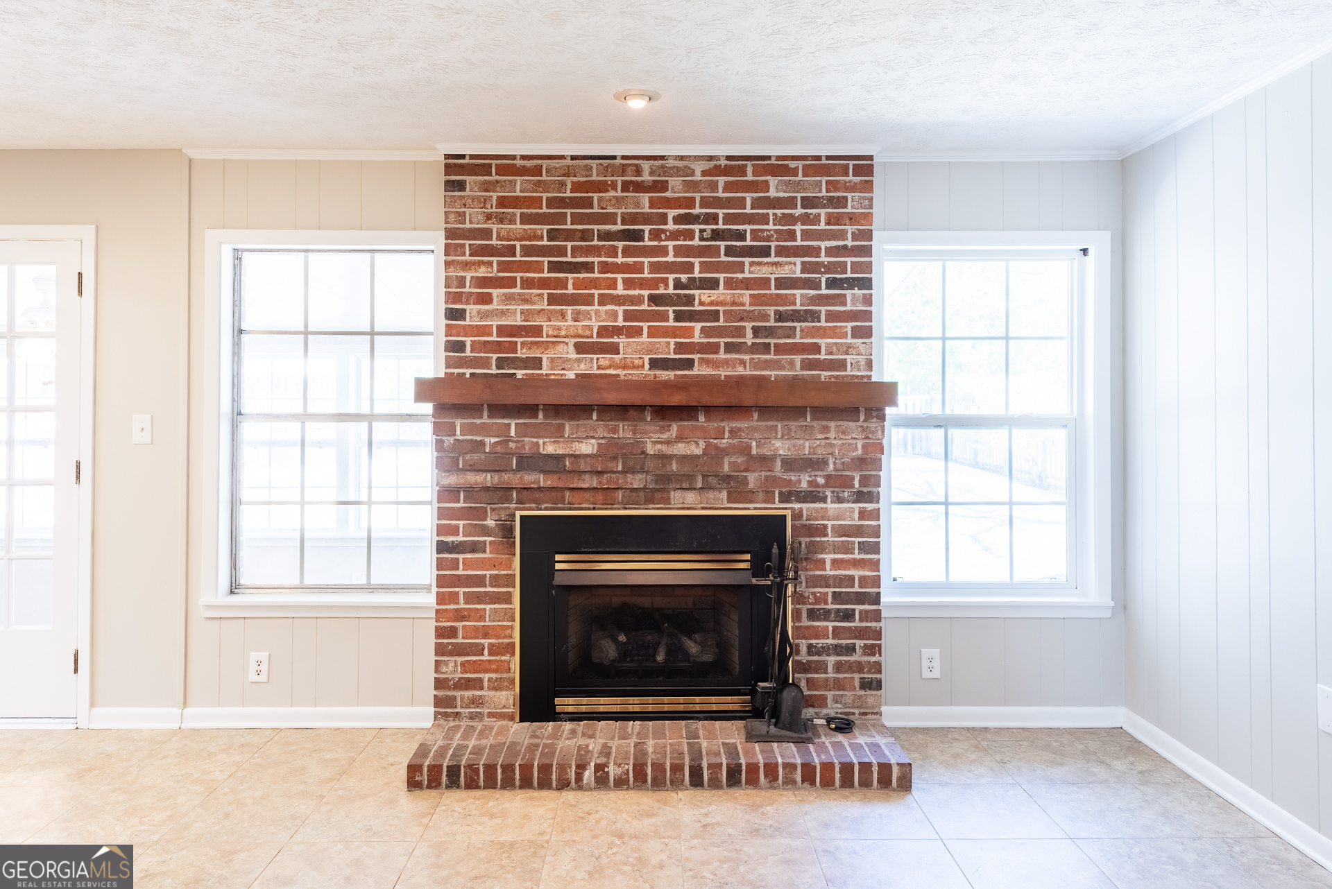 4582 St Johns Church Road Blackshear, GA 31516 - Photo 41 of 76 a living room with a fireplace and windows