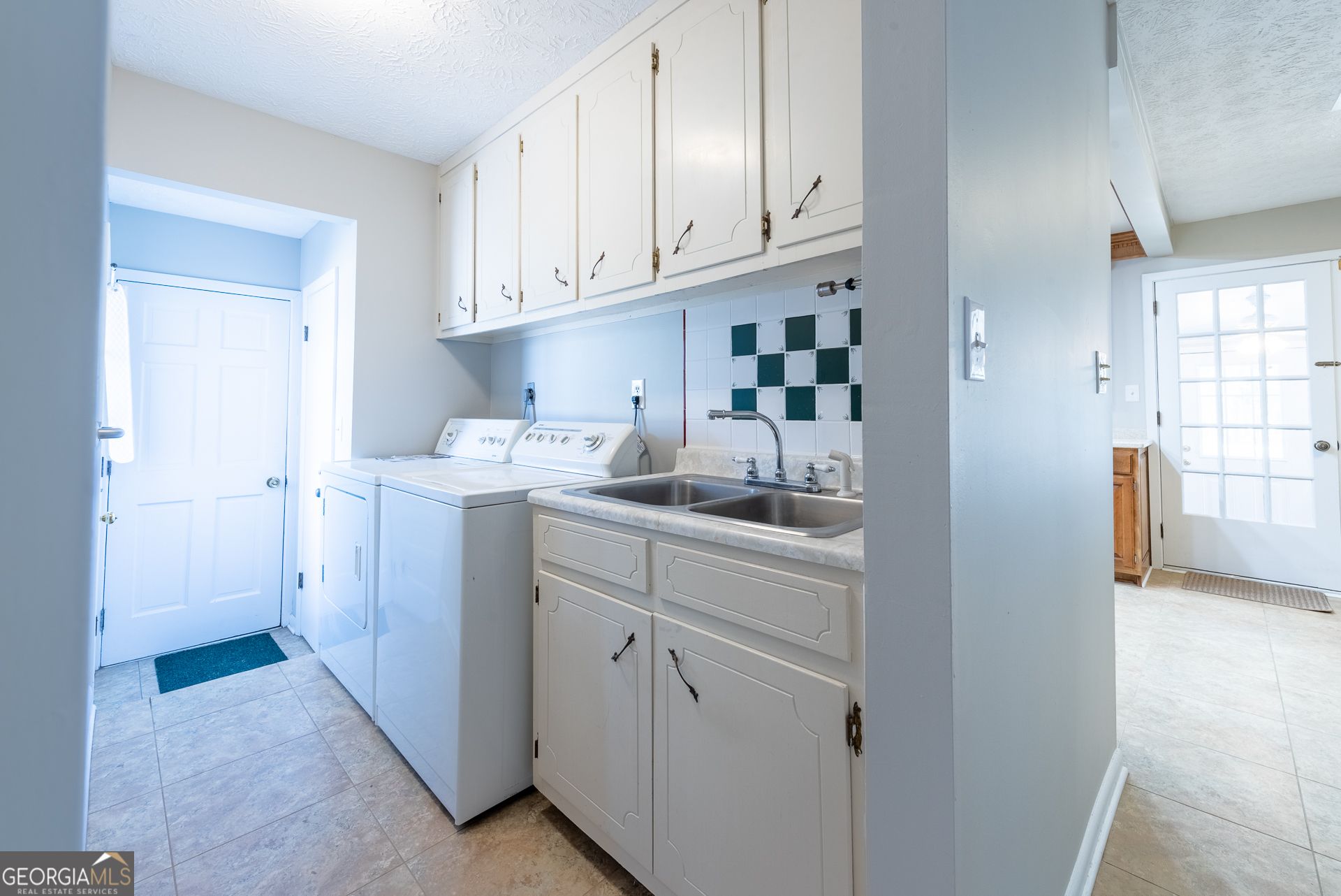 4582 St Johns Church Road Blackshear, GA 31516 - Photo 48 of 76 a kitchen with white cabinets and sink