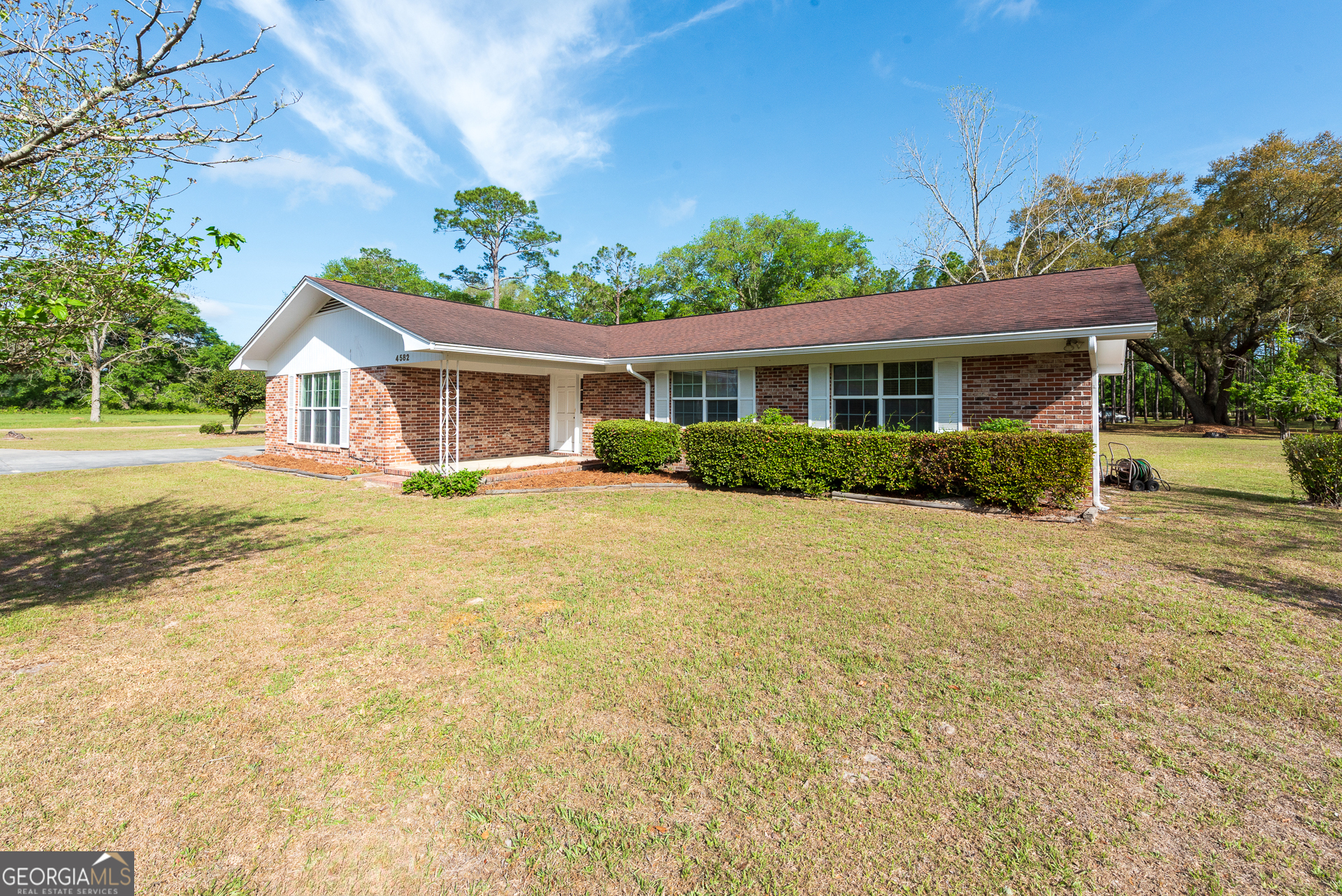 4582 St Johns Church Road Blackshear, GA 31516 - Photo 5 of 76 a front view of a house with a yard and potted plants