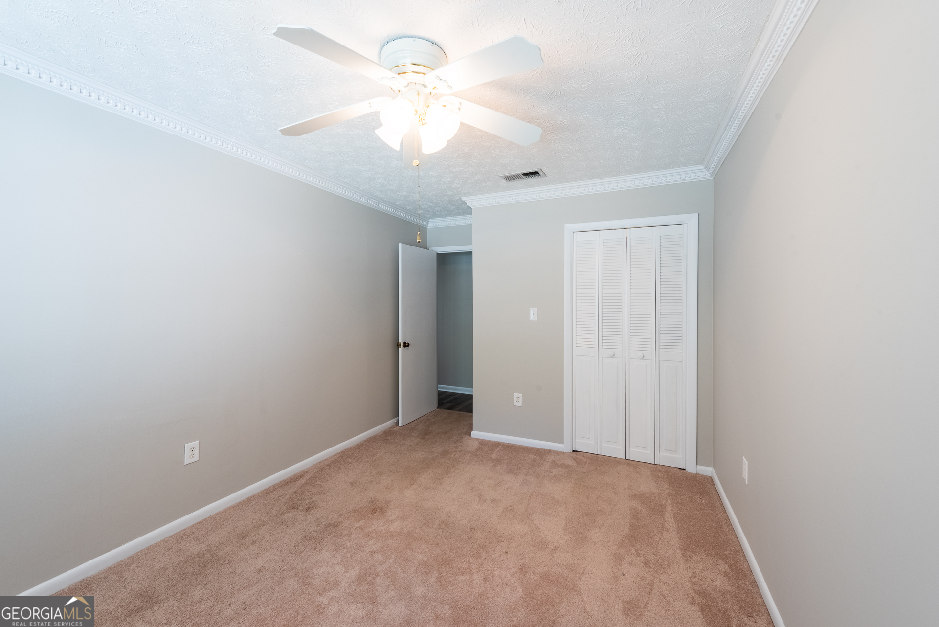 4582 St Johns Church Road Blackshear, GA 31516 - Photo 58 of 76 an empty room with a ceiling fan and a window