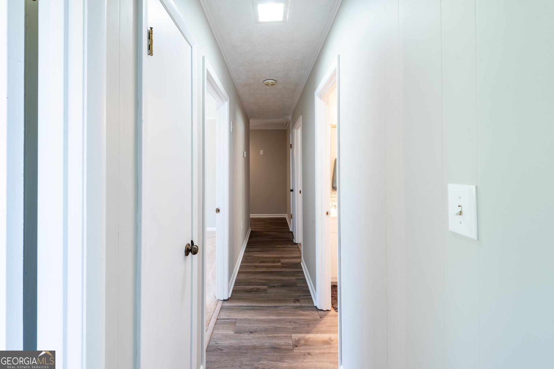 4582 St Johns Church Road Blackshear, GA 31516 - Photo 68 of 76 a view of a hallway with wooden floor and stairs