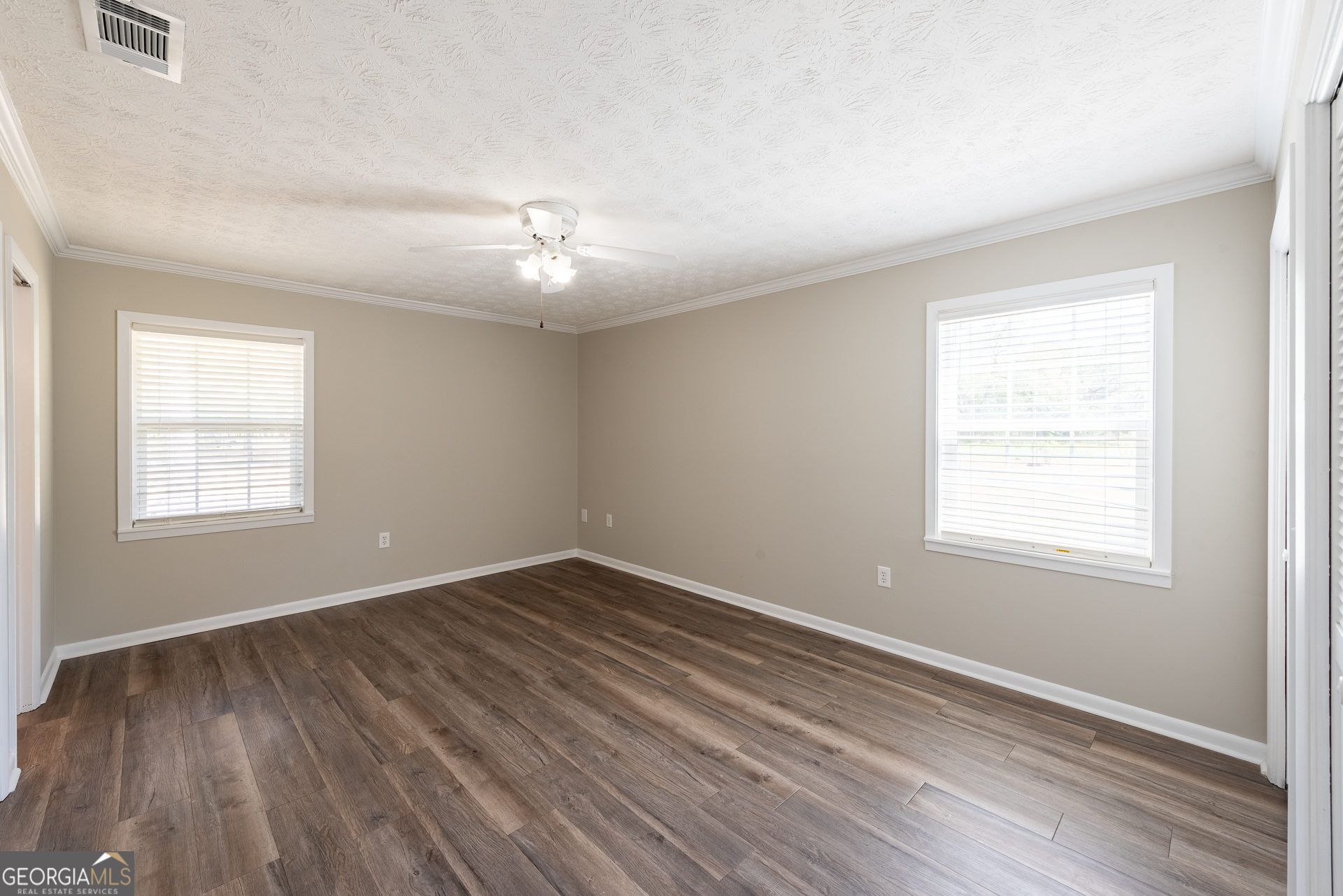 4582 St Johns Church Road Blackshear, GA 31516 - Photo 69 of 76 a view of an empty room with wooden floor and a window