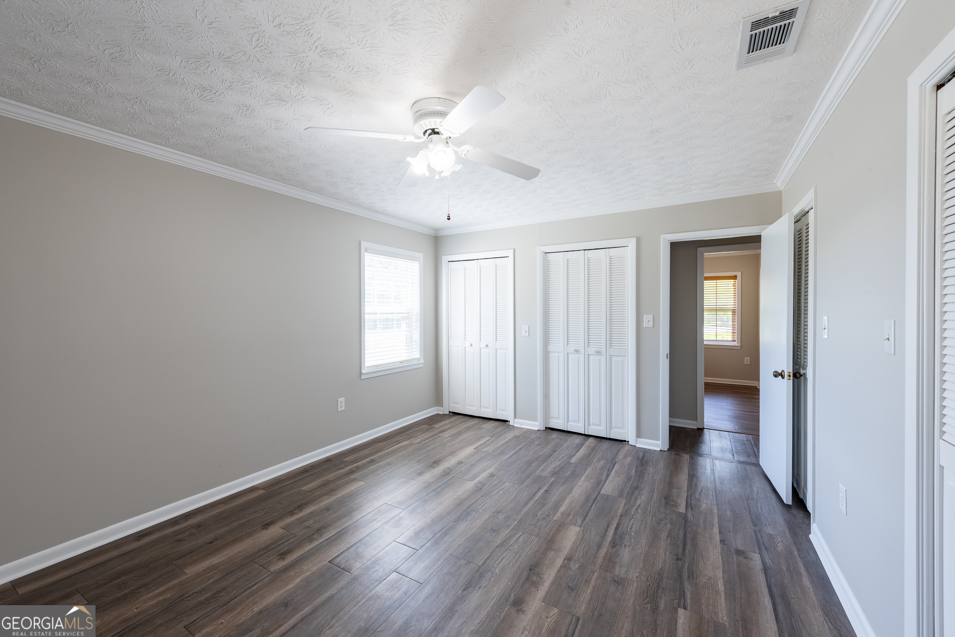 4582 St Johns Church Road Blackshear, GA 31516 - Photo 71 of 76 an empty room with wooden floor and windows