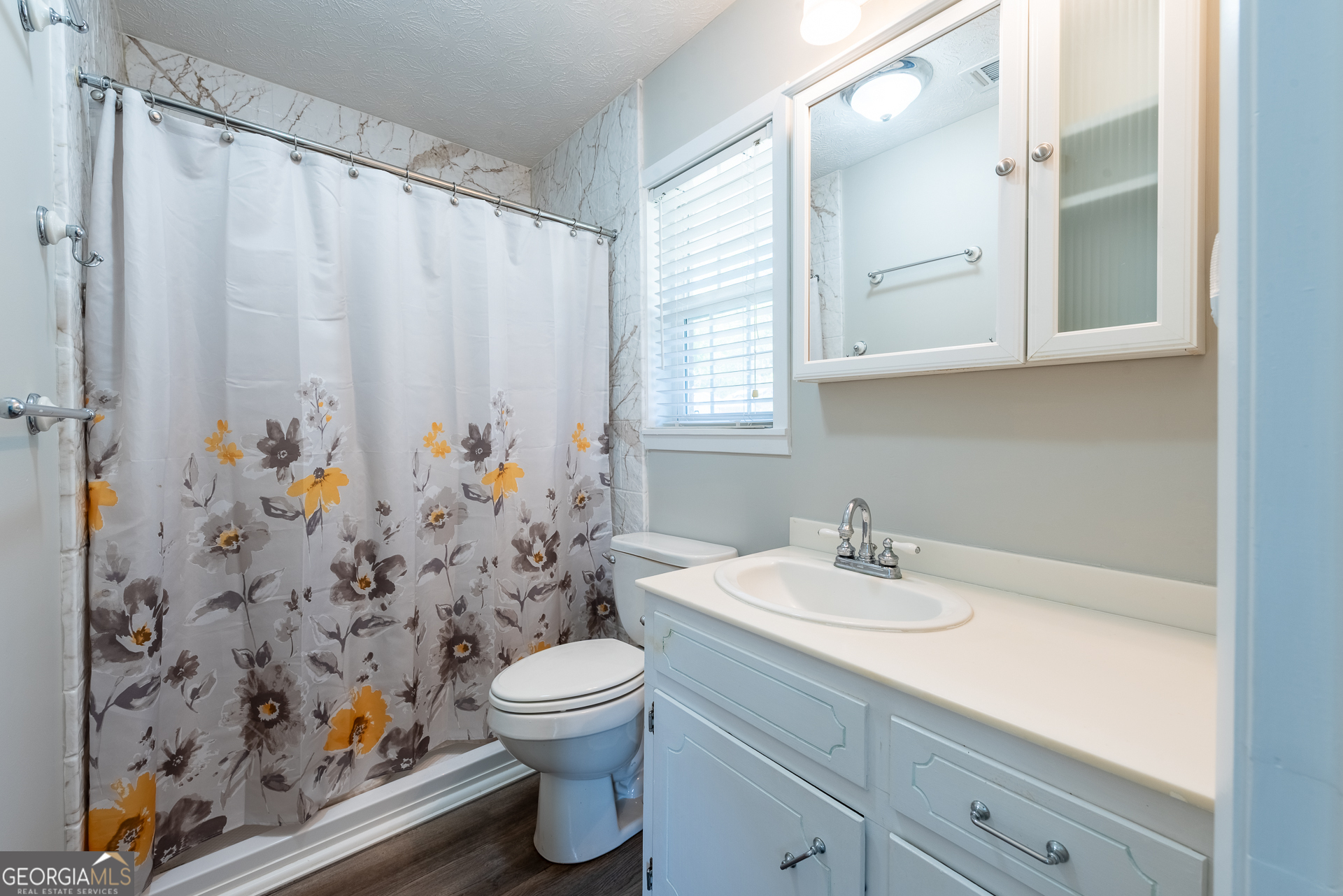 4582 St Johns Church Road Blackshear, GA 31516 - Photo 72 of 76 a bathroom with a sink a toilet and shower curtain