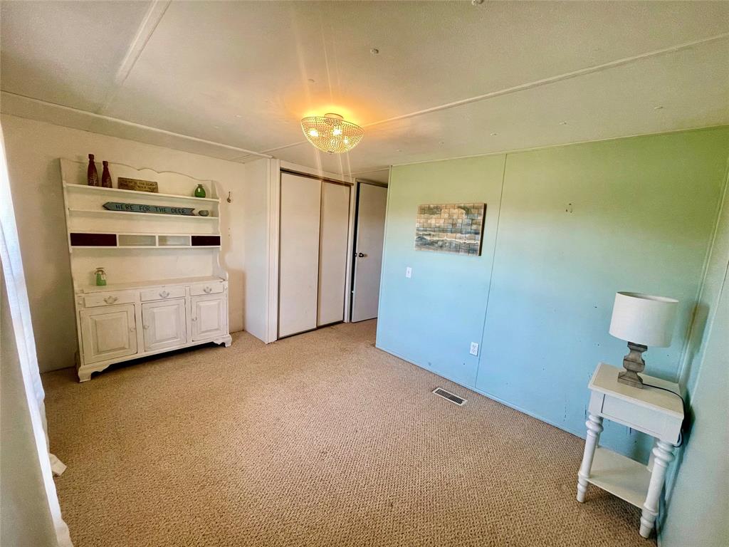 2334 San Bar Road, Unit 96 Graford, TX 76449 - Photo 29 of 40 Primary bedroom with new light fixture, and a large window.