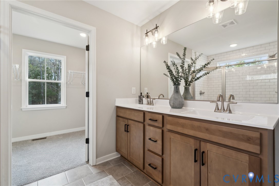 Tbd North Shore Road Locust Hill, VA 23092 - Photo 12 of 40 a bathroom with a double vanity sink a mirror and a shower