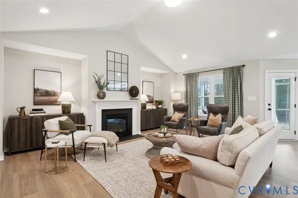 a kitchen with stainless steel appliances a stove center island a stove and a wooden floor